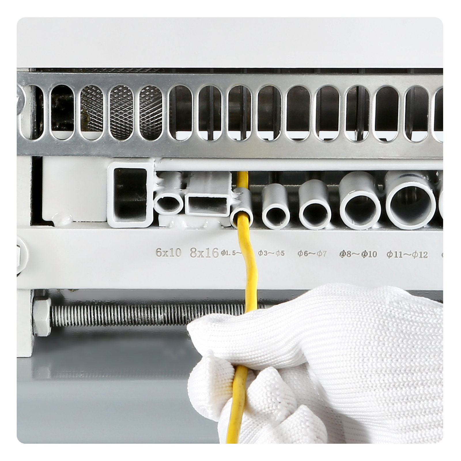 hand using VEVOR automatic wire stripping machine with yellow wire and multiple stripping options.