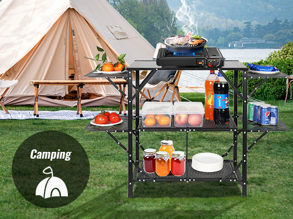 camping setup with a tent and a VEVOR camping kitchen table holding food, beverages, and cooking tools.