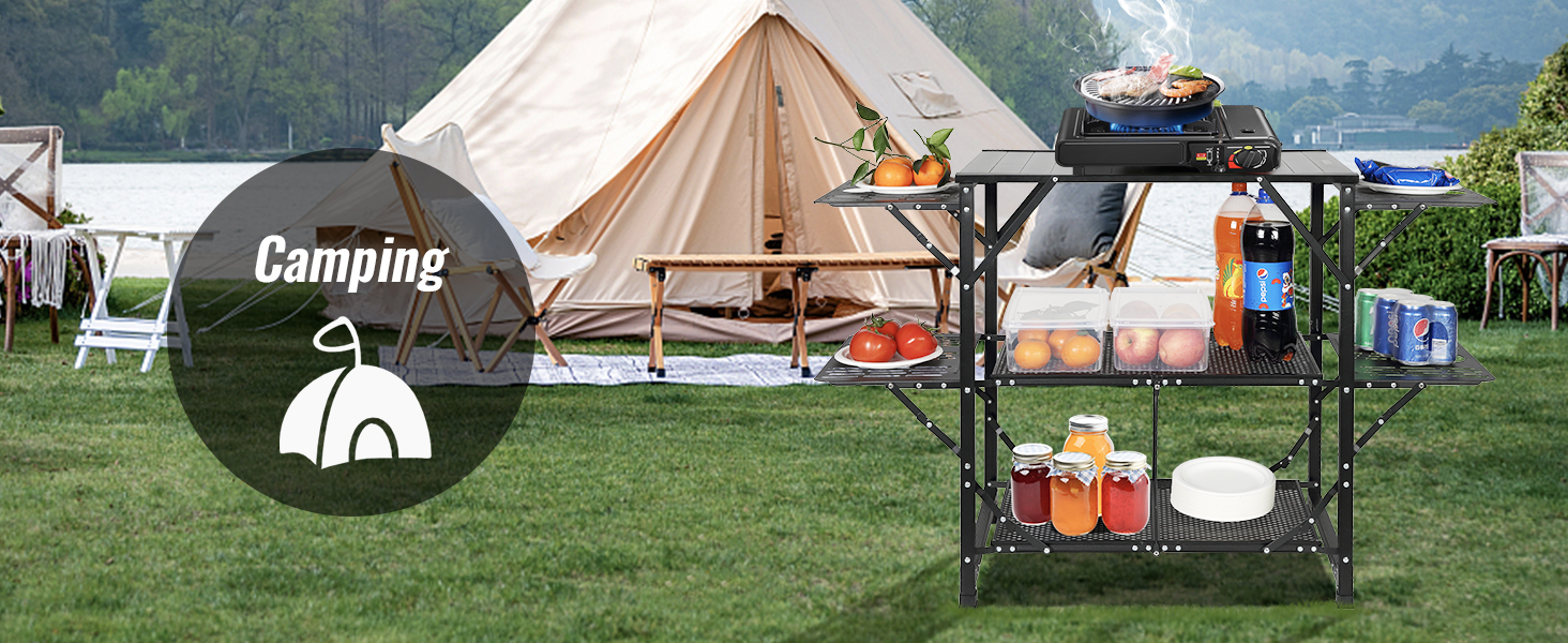 camping setup with a tent and a VEVOR camping kitchen table holding food, beverages, and cooking tools.