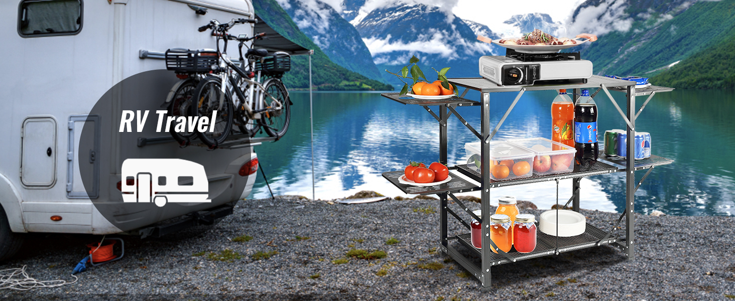 camper by a lake with a VEVOR camping kitchen table, stocked with food and drinks, bicycles mounted.