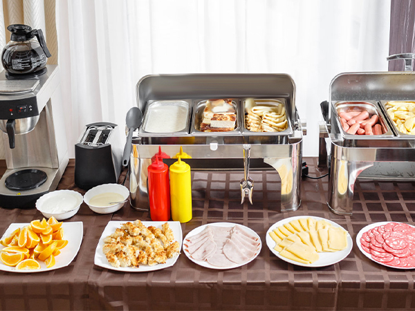 buffet setup with a VEVOR commercial food warmer, various dishes, condiments, and coffee machines.