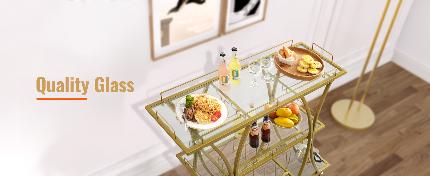 gold metal and glass VEVOR bar cart with food and drinks, against a white wall with framed pictures.