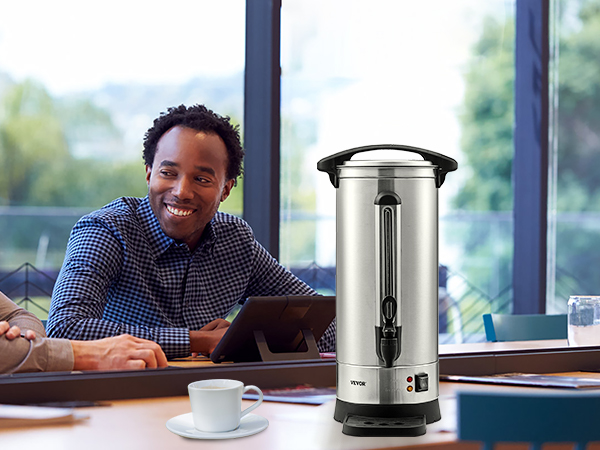 VEVOR coffee urn on a table, surrounded by people in a meeting with coffee and coffee beans nearby.