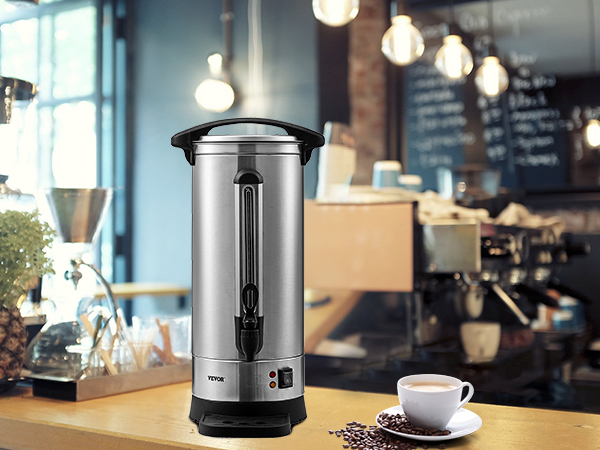 VEVOR coffee urn on a cafe counter with coffee beans, a cup, and blurred background lighting.