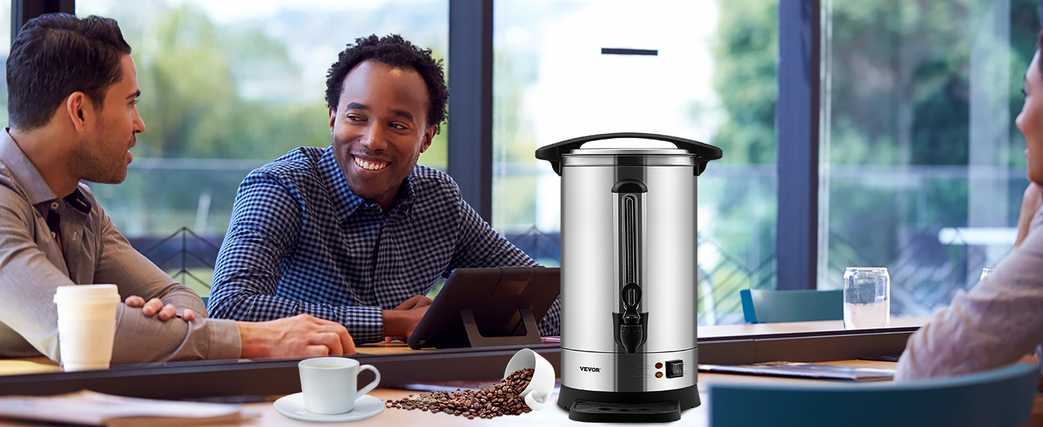 VEVOR coffee urn on a meeting table with people, a cup of coffee, and spilled coffee beans nearby.