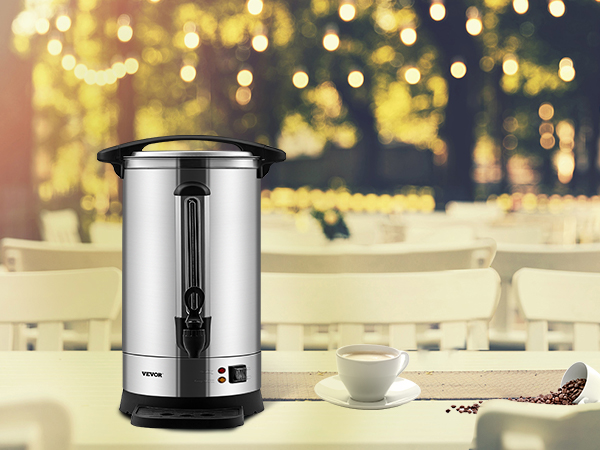 VEVOR coffee urn on a table with spilled coffee beans and a cup, set in an outdoor café environment.