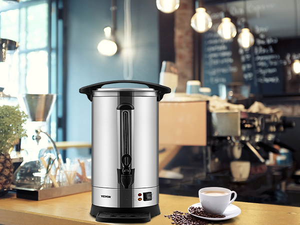 VEVOR coffee urn in a cozy café setting with a cup of coffee, espresso machine, and decorative plants.