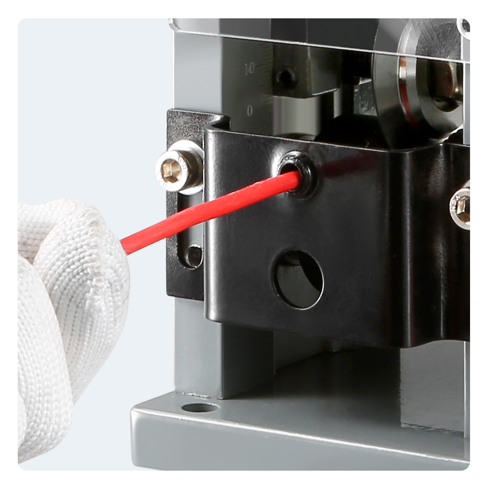 hand feeding red wire into VEVOR wire stripping machine for precision stripping.