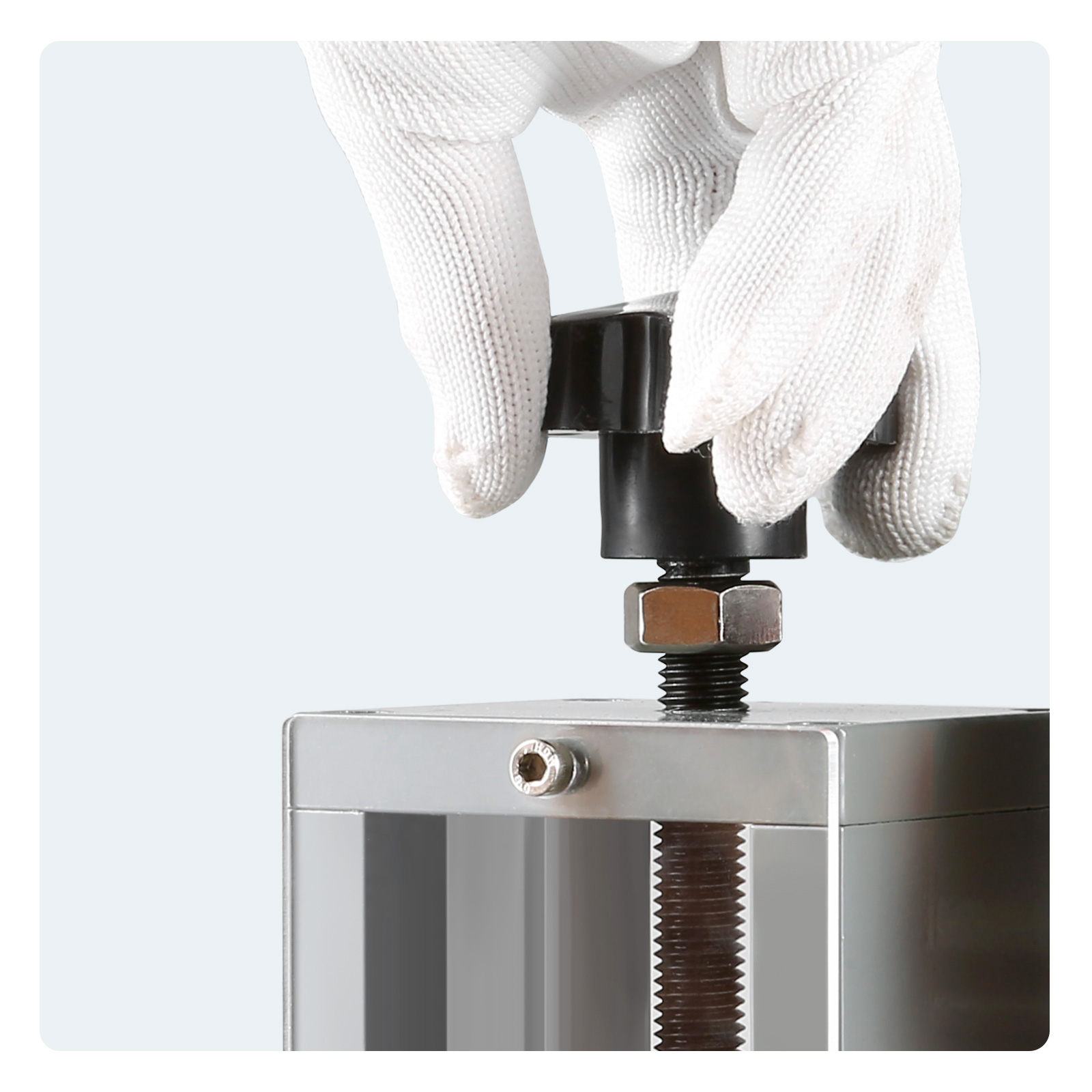 hand adjusting the knob of a VEVOR wire stripping machine with a white glove.