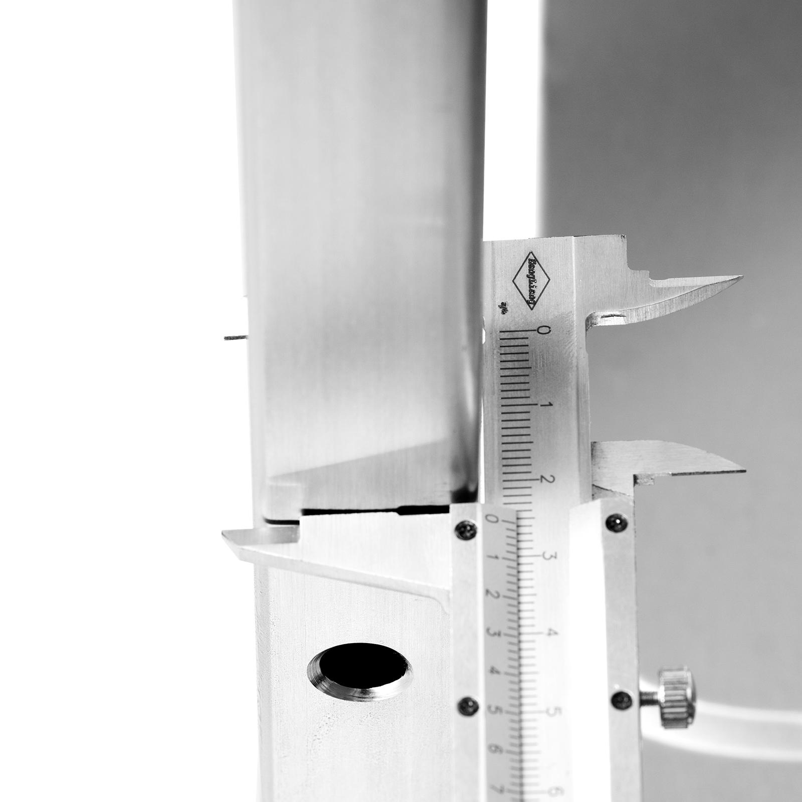 caliper measuring metal component of VEVOR kitchen utility cart; close-up on measurement details.