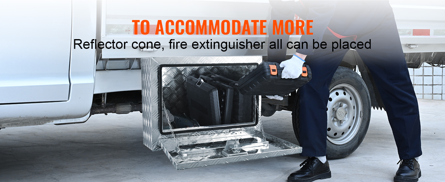 man placing a toolbox in a VEVOR underbody truck box attached to a white truck for storage solutions.