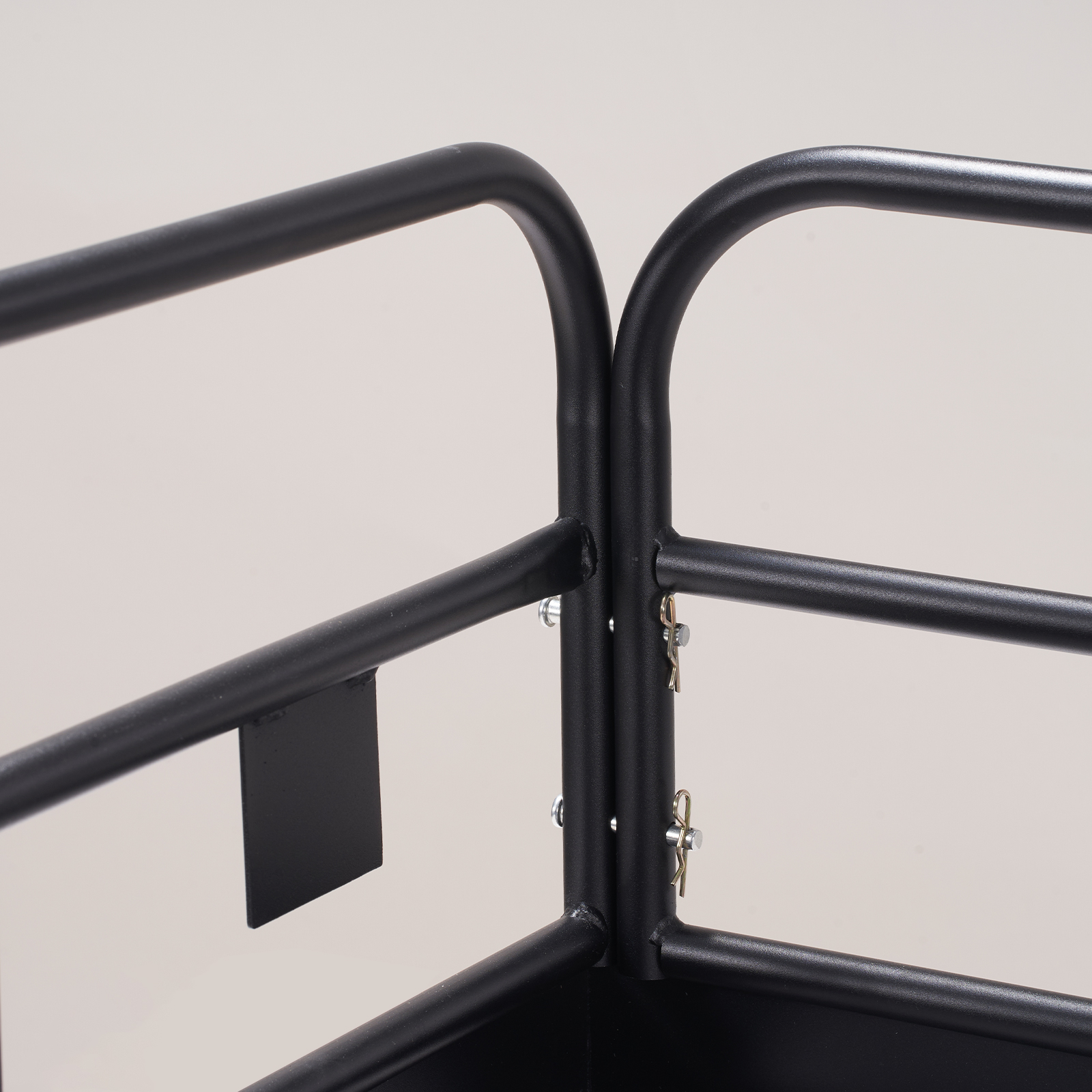 close-up of the VEVOR trail hitch cargo carrier's black metal frame with secure bolts and a minimalist design.