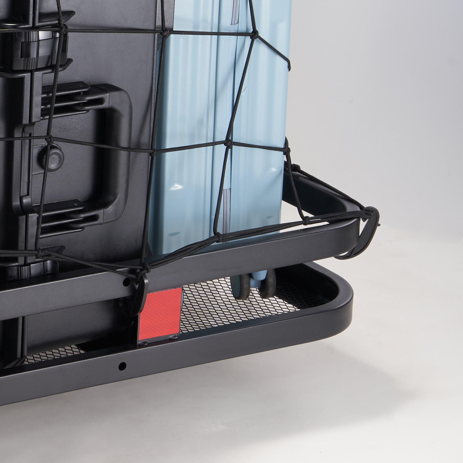 cargo secured in a VEVOR hitch cargo carrier with mesh net, holding black and blue luggage.