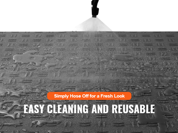 hosing water on VEVOR garage tiles for easy cleaning and reuse, showing water resistance.