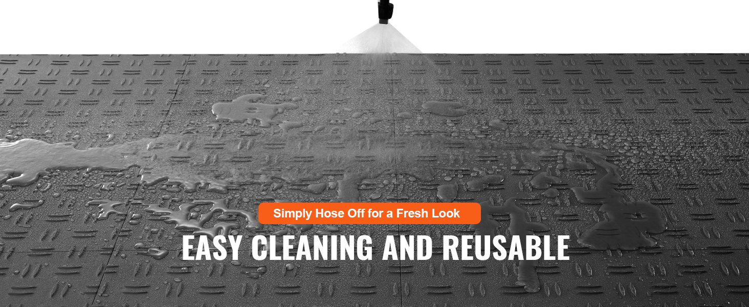 hosing water on VEVOR garage tiles for easy cleaning and reuse, showing water resistance.