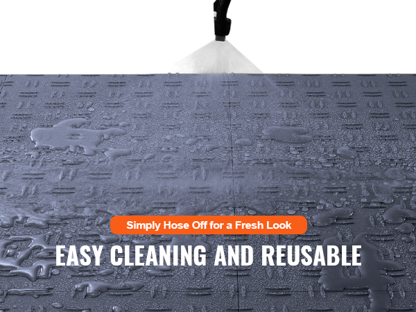 spraying water on VEVOR garage tiles for easy cleaning and reusable functionality.