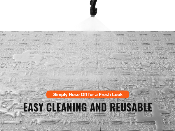 VEVOR garage tiles being hosed off for easy cleaning, showcasing reuse and maintenance benefits.