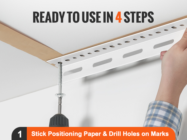 hand installing the VEVOR overhead garage storage rack with a drill and positioning paper.