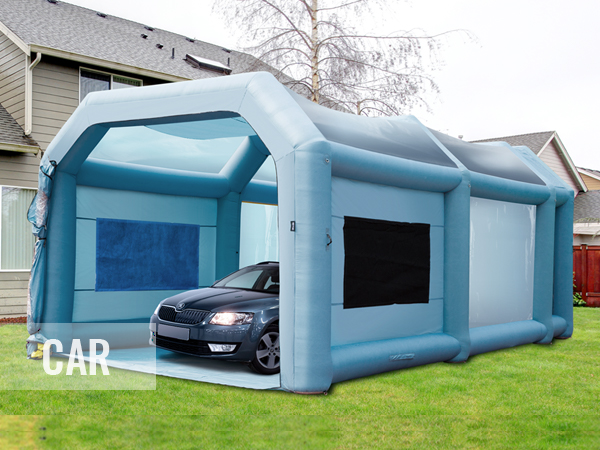 VEVOR inflatable paint booth with a car inside, set up in a backyard.