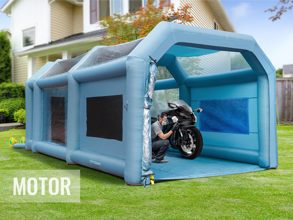 VEVOR inflatable paint booth set up in a backyard, featuring a person working on a motorcycle inside.