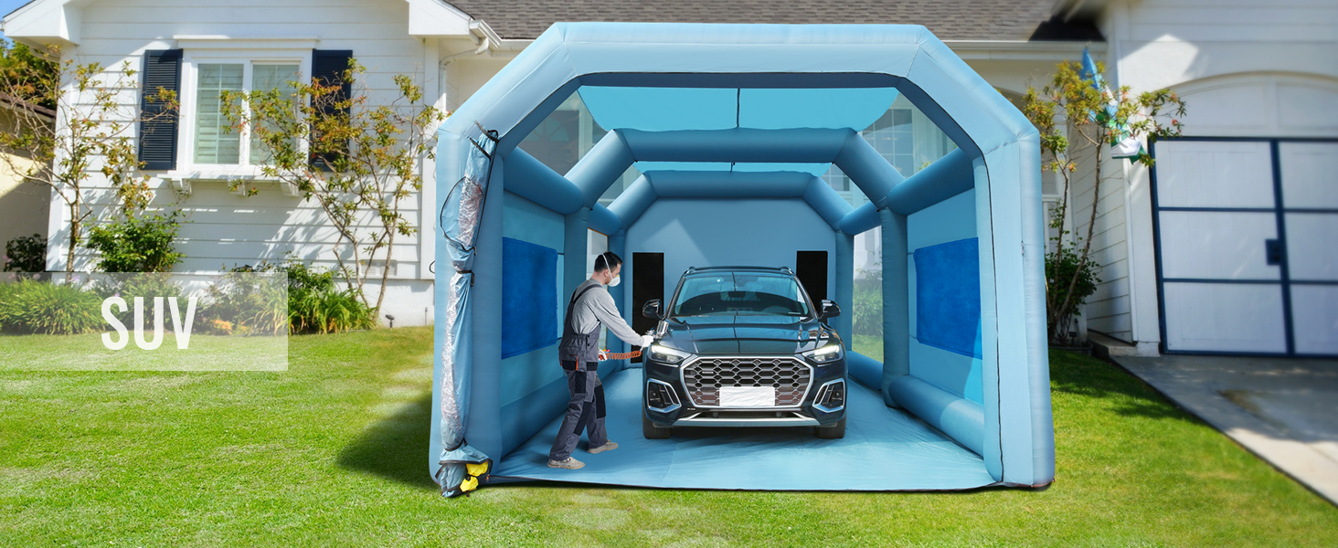 VEVOR inflatable paint booth setup in front of a house with an suv inside and person working.