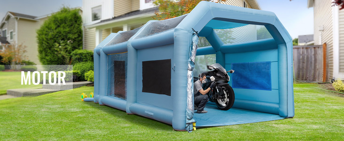 VEVOR inflatable paint booth set up in a backyard with a person working on a motorcycle inside.