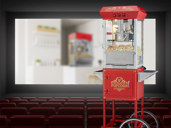 red VEVOR popcorn popper machine on wheels in an empty theater with red seats and a screen background.