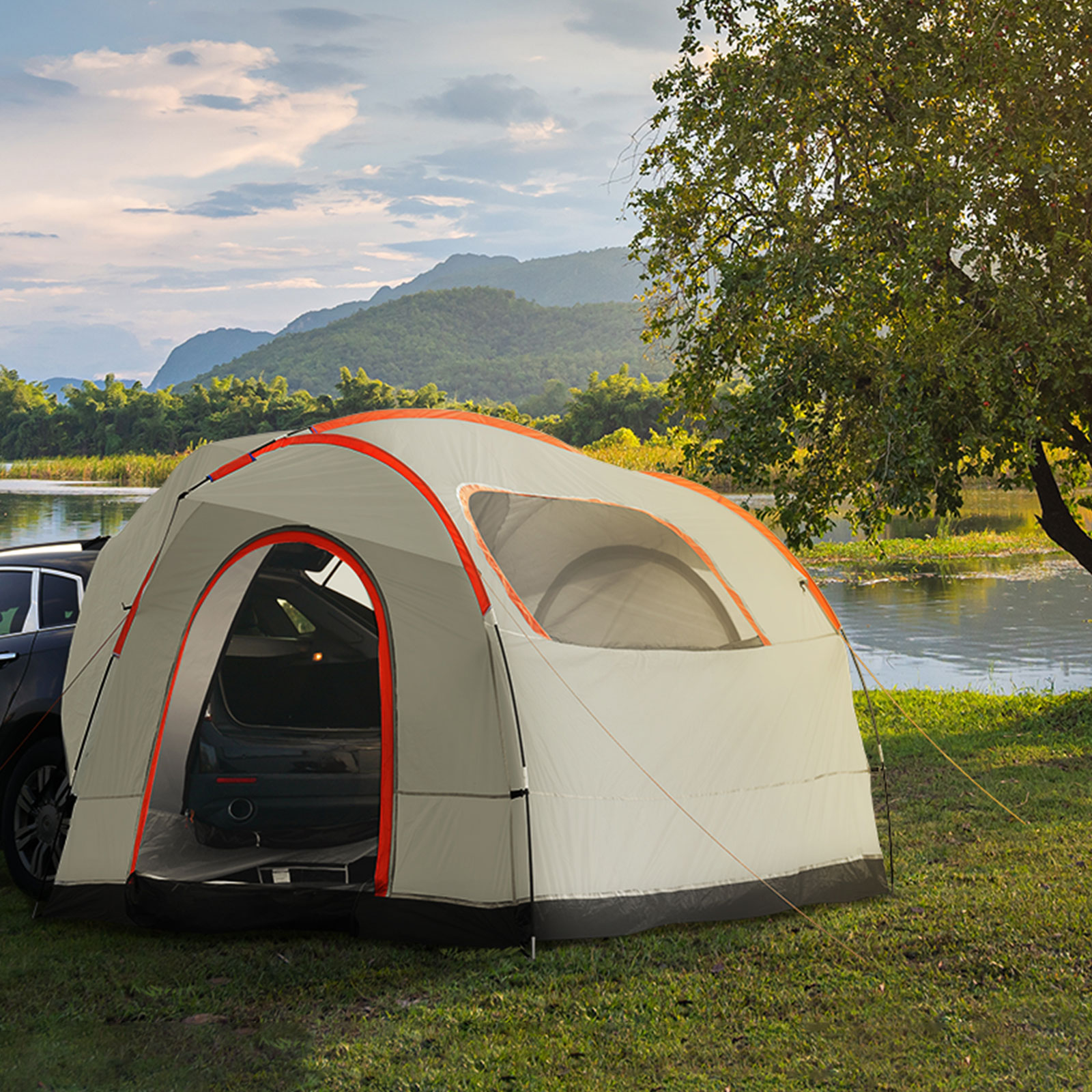suv parked beside VEVOR suv camping tent near a serene lake with mountains and trees in the background.