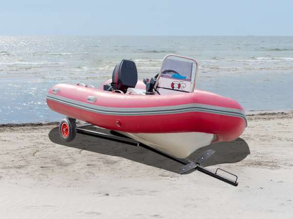 red boat on sandy beach with VEVOR boat trailer dolly, ocean waves in the background.