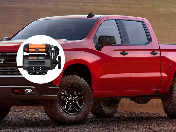 red pickup truck in rugged terrain with VEVOR onboard air compressor kit inset.