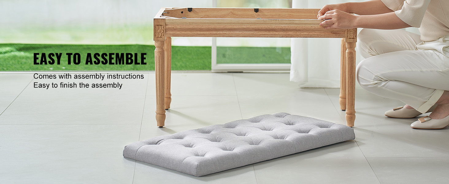 person assembling VEVOR upholstered bench with wooden legs and a gray cushion on a tile floor.