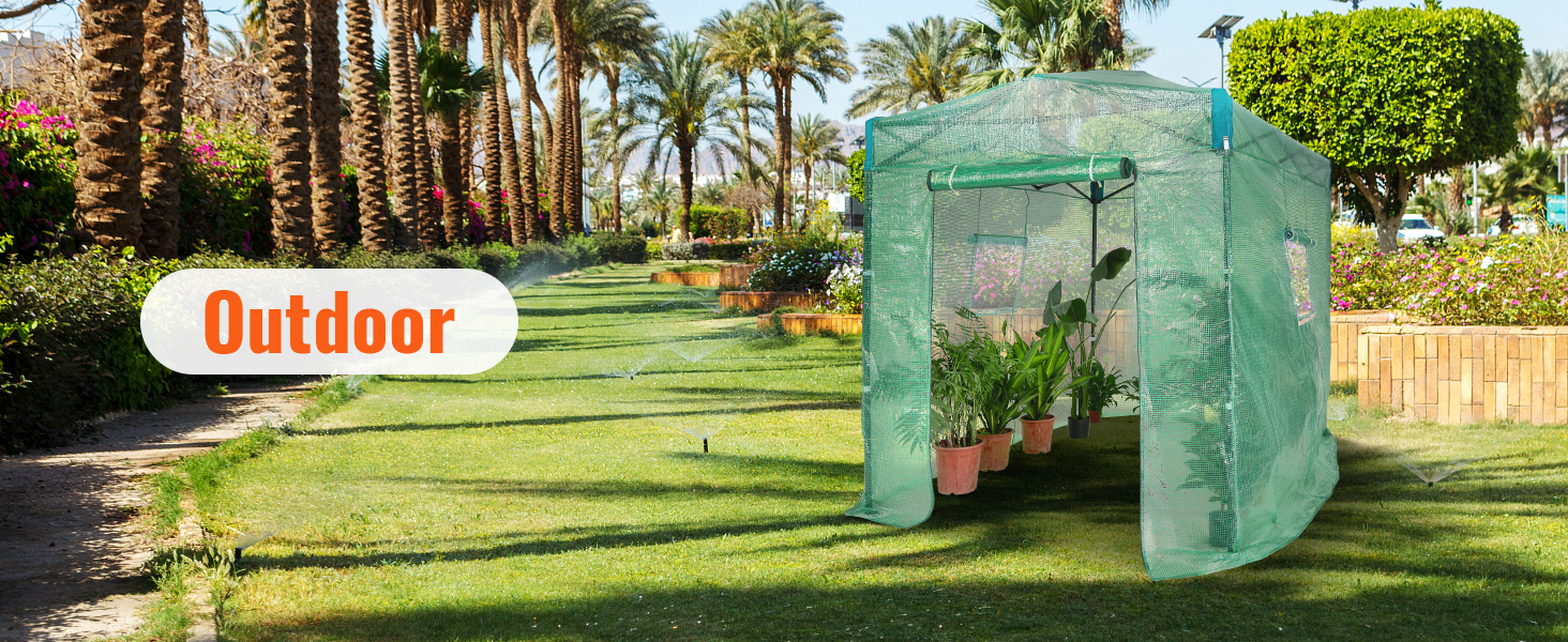 VEVOR pop up greenhouse on a sunny lawn surrounded by palm trees and vibrant garden flowers.