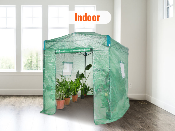 indoor VEVOR pop up greenhouse with green mesh, housing potted plants, placed on a wooden floor.