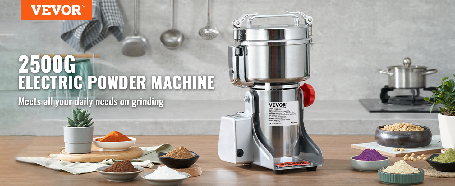 VEVOR electric grain mill with bowls of colorful powders, utensils, and plants on a kitchen countertop.