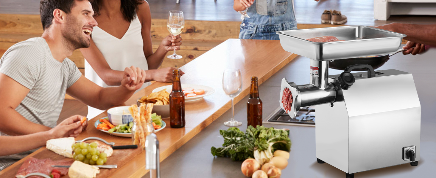 people enjoying a meal around a table with snacks, drinks, and a VEVOR electric meat grinder in a kitchen.