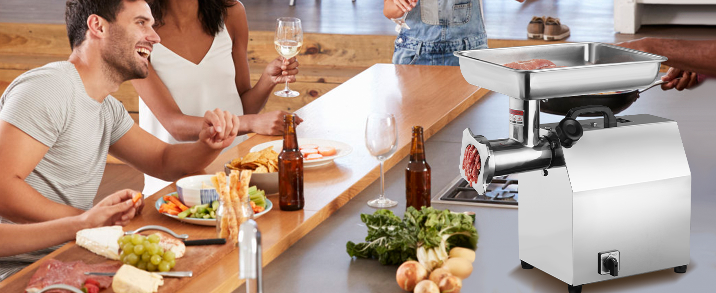 group enjoying a meal around a table with a VEVOR electric meat grinder and fresh ingredients.