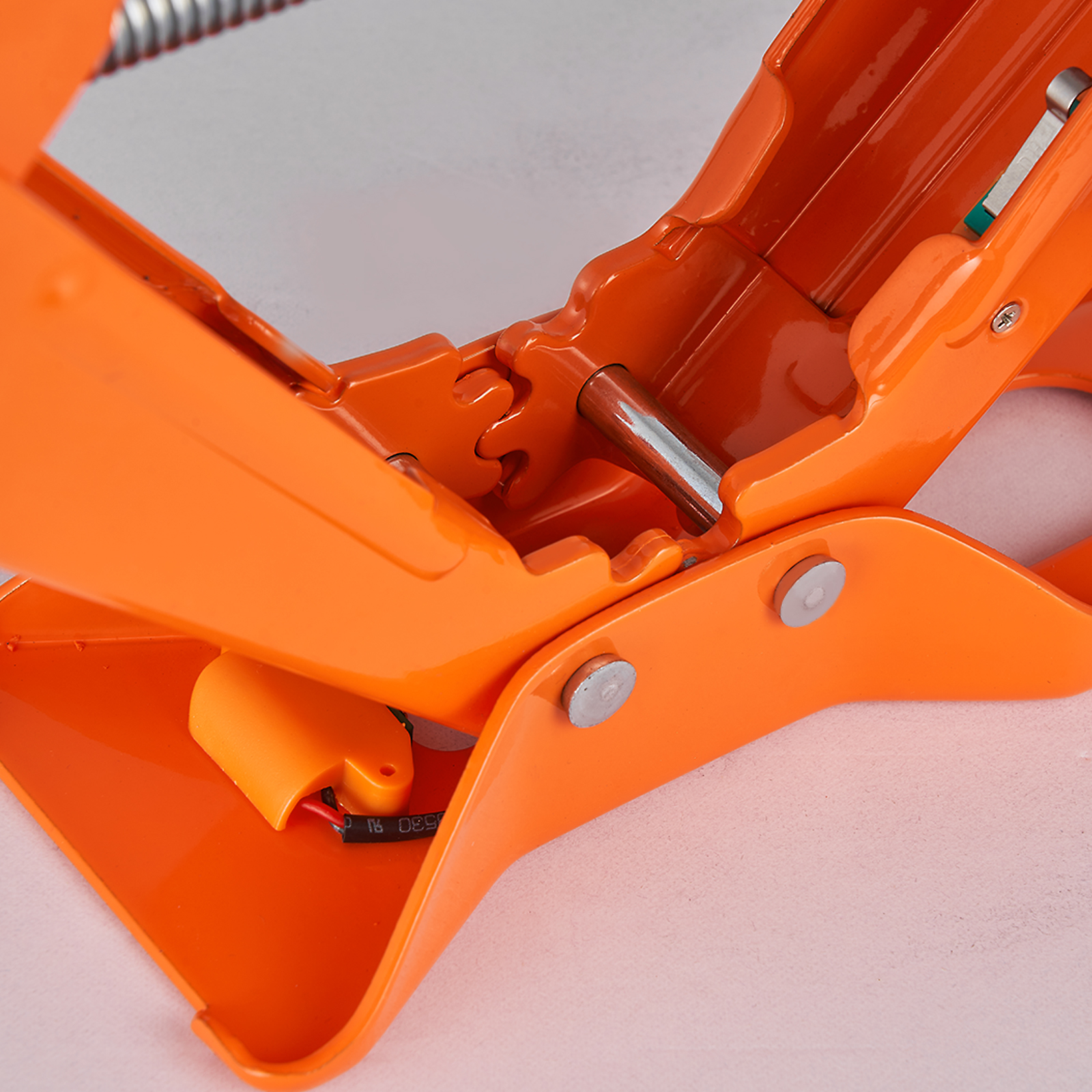 orange VEVOR electric car jack close-up showing mechanical components and connections.