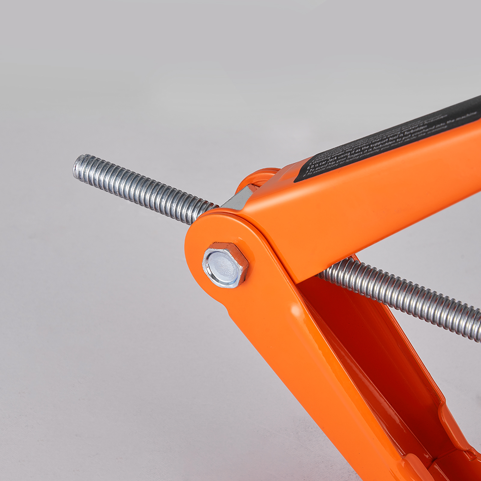 close-up of orange VEVOR electric car jack with visible screw and bolt mechanism.