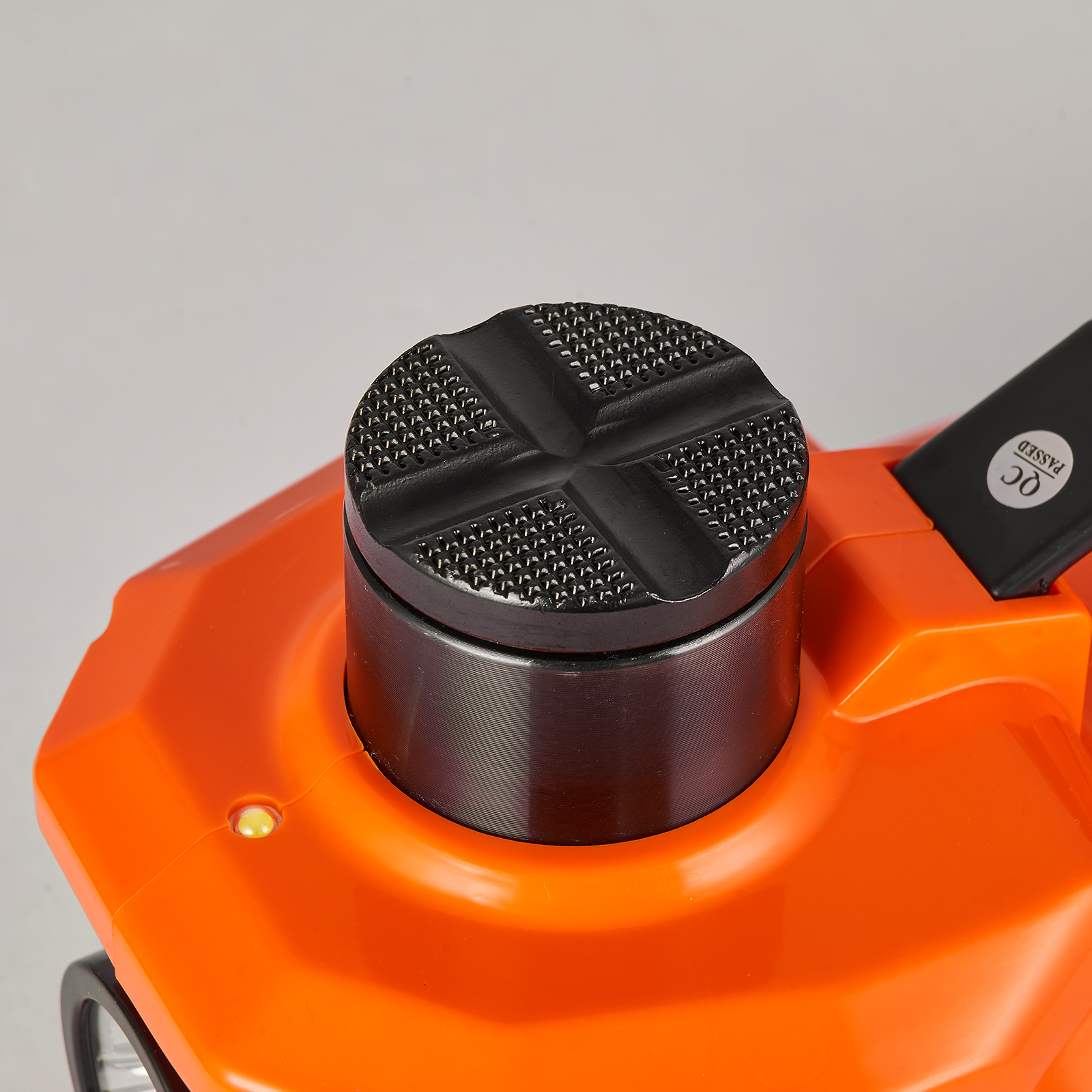 close-up of VEVOR electric car jack with an orange body and textured black lifting pad.