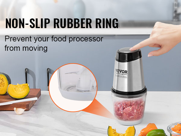 VEVOR food processor with non-slip rubber ring, fresh vegetables on the table, hand pressing lid.