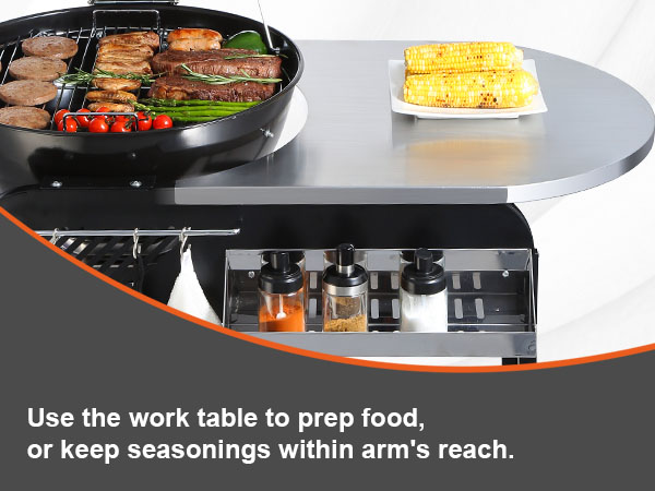 VEVOR charcoal grill with work table, assorted grilled food, and seasonings within arm's reach.