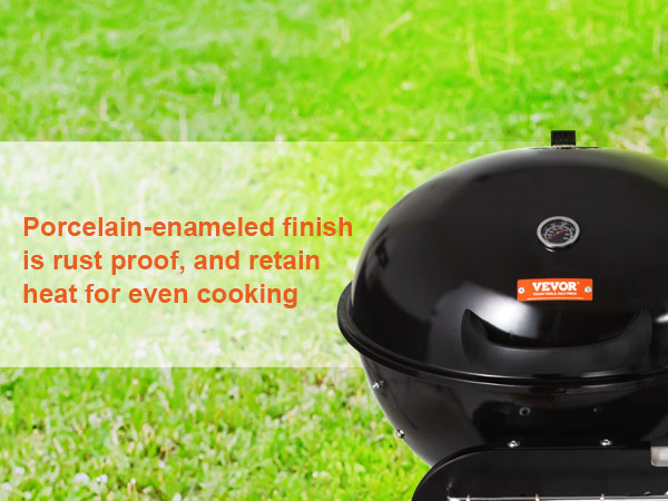 black VEVOR charcoal grill on green grass with heat-retentive porcelain-enamel finish for even cooking.