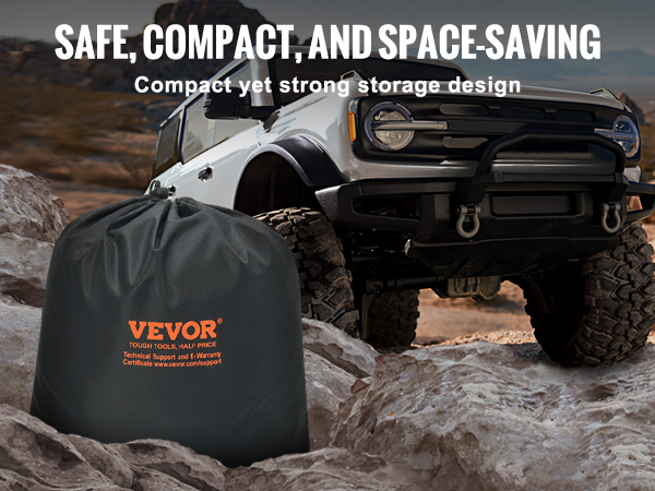 VEVOR tow strap in a compact black storage bag next to an off-road vehicle on rocky terrain.