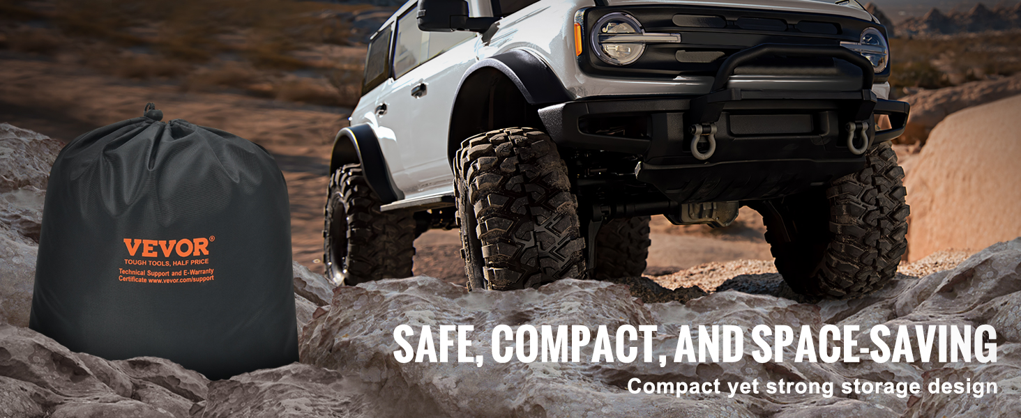 VEVOR tow strap in a compact black storage bag next to an off-road vehicle on rocky terrain.