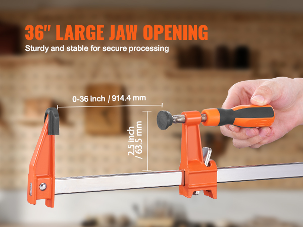 36" VEVOR bar clamp with large jaw opening for secure processing in a workshop setting.