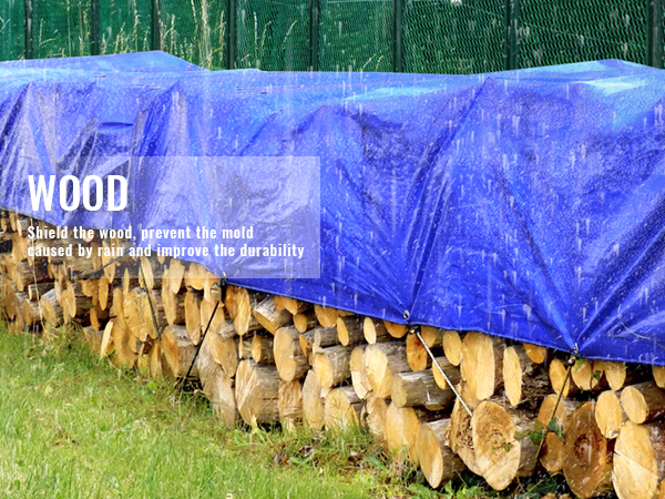 woodpile covered with a blue VEVOR waterproof tarp protecting logs from rain.