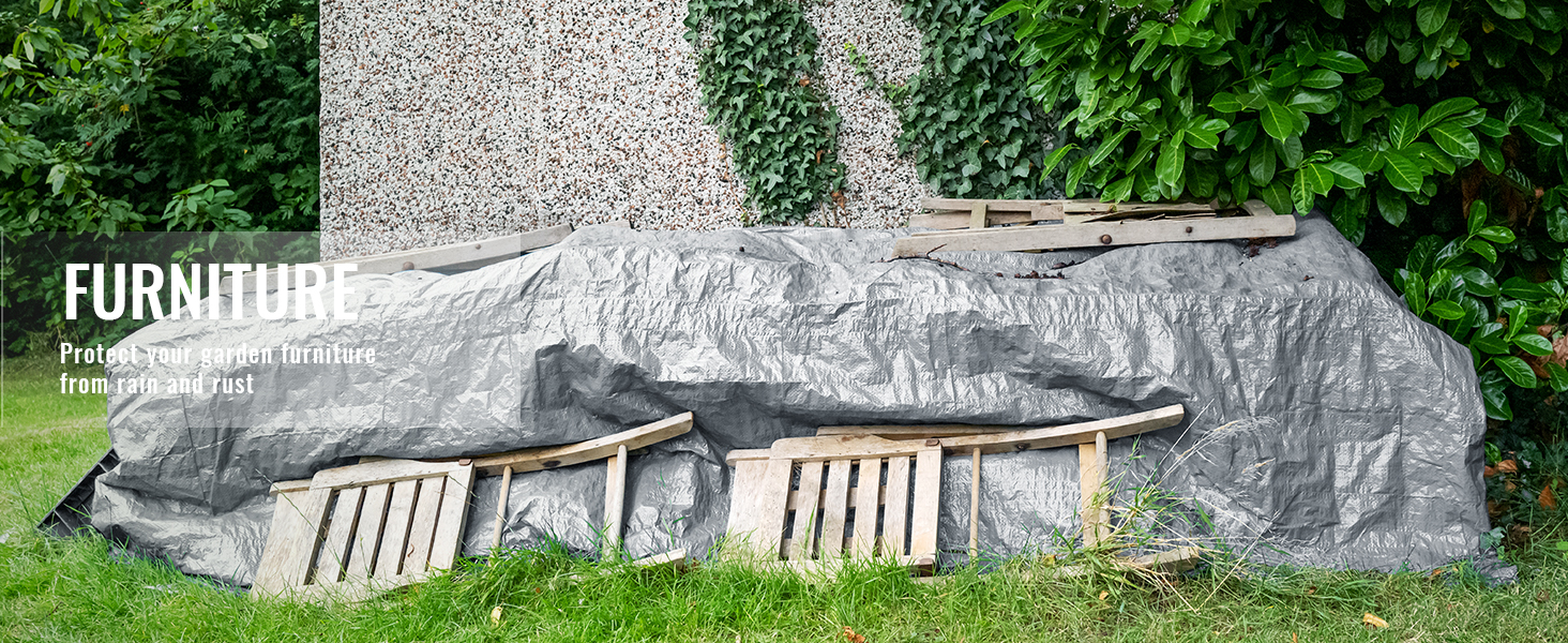 VEVOR waterproof tarp covering garden furniture beside ivy-clad wall and lush greenery.