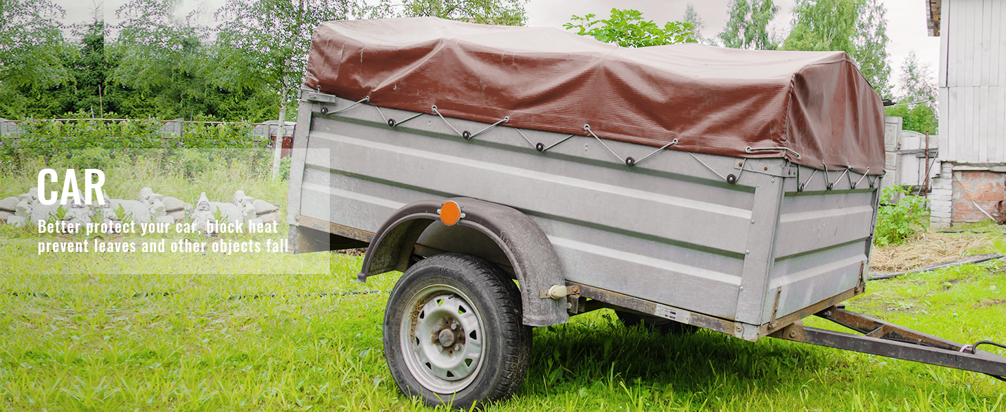 VEVOR waterproof tarp covering a trailer, protecting from elements in a green outdoor setting.