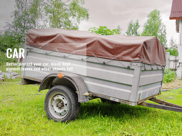 trailer covered with a brown VEVOR extra thick waterproof tarp in a grassy backyard.