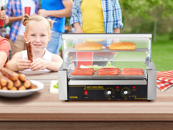 kids enjoy hot dogs at an outdoor event, featuring the VEVOR hot dog roller on a picnic table.